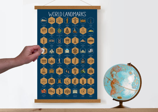 World Landmarks scratch off poster. Has a navy background with colorful icons for each landmark. Scratch off a gold layer to reveal artwork. Hanging on a wooden frame.