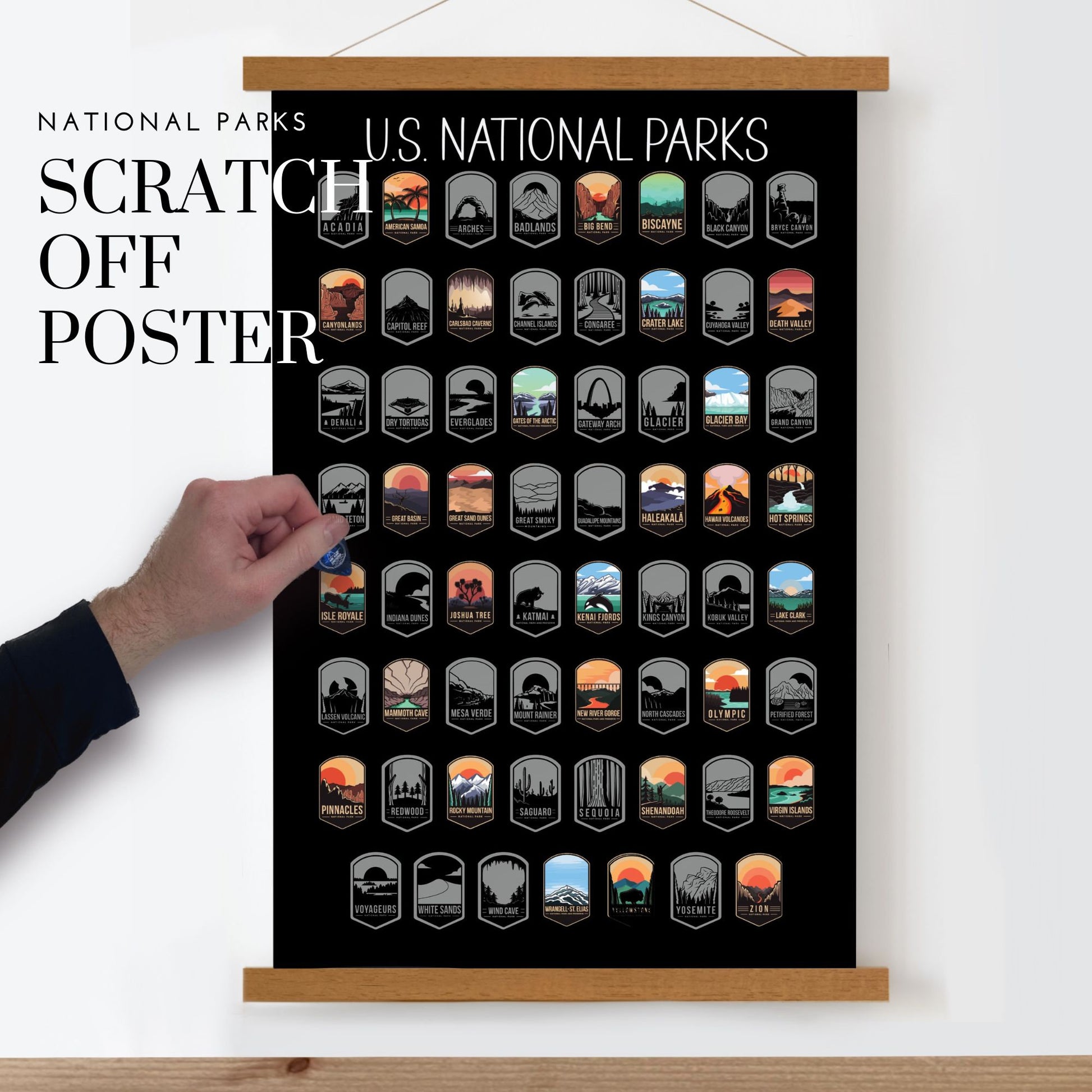 63 National Park scratch off poster, Has a black background with colorful icons for each park. Scratch off a silver layer to reveal artwork. Hanging on a wooden frame.