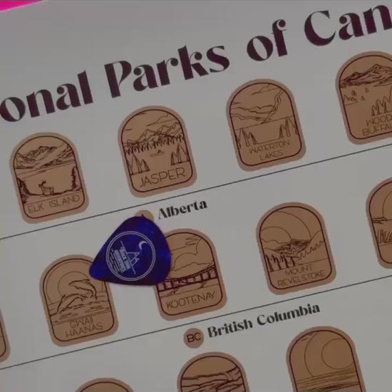 Video of someone scratching off the top gold layer on the Canadian National Parks scratch off poster.