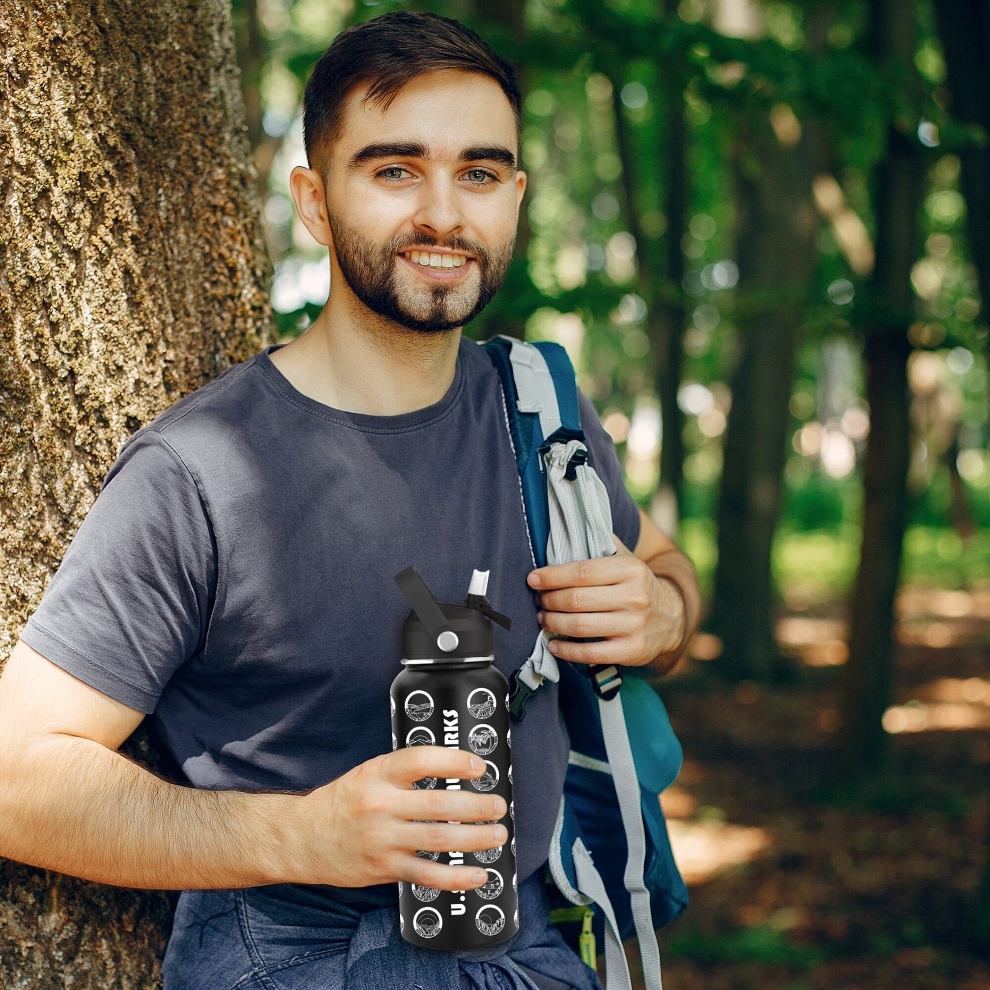 Man holding National Parks Water Bottle outside.